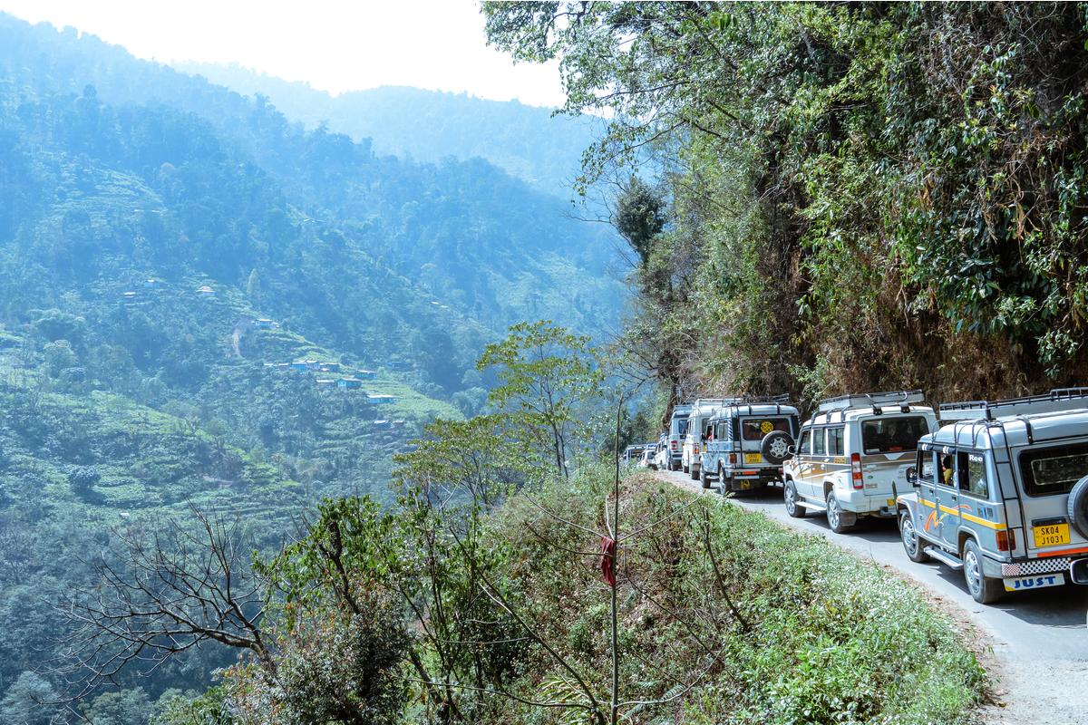 Guests with the vehicle on a hill road